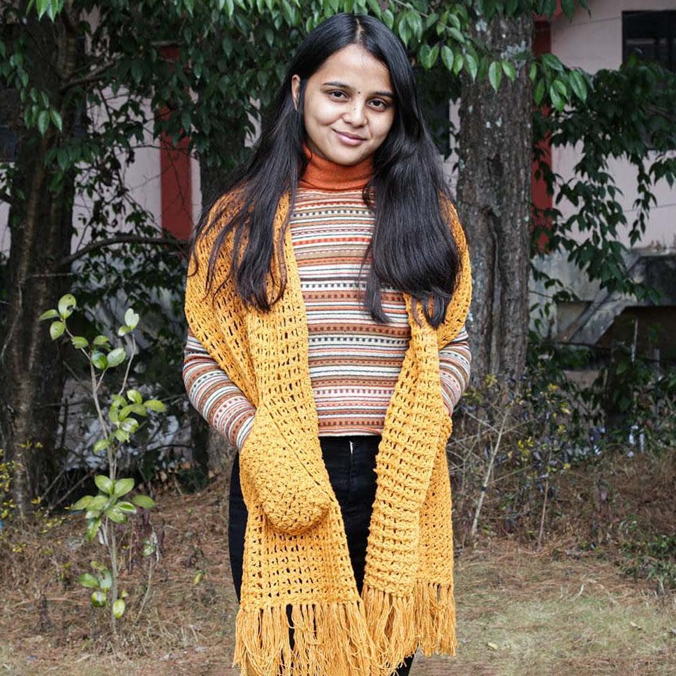 A Women Wearing A Yellow Eri Silk Crochet Pocket Shawl  