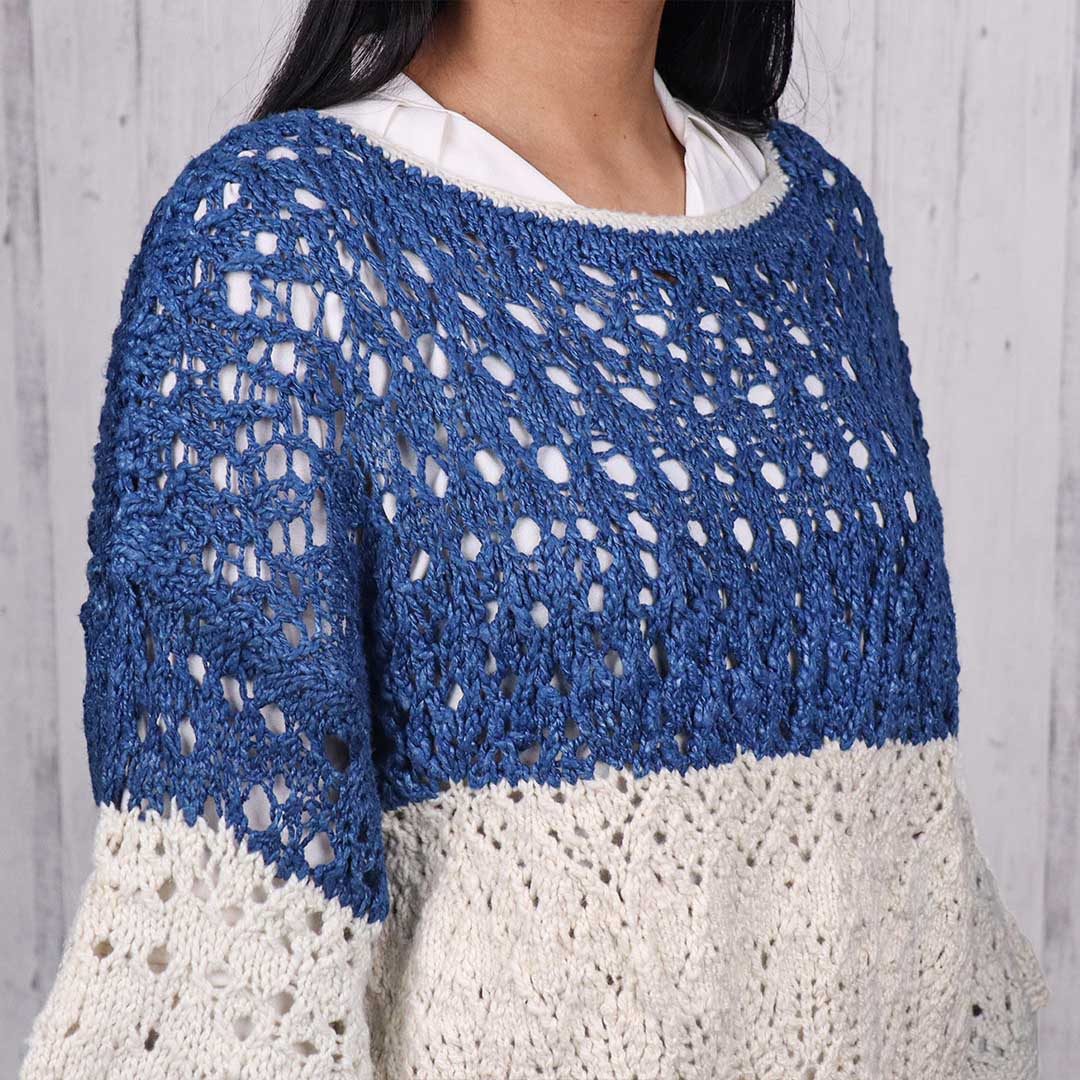 Woman wearing a silk blue knitted open sweater