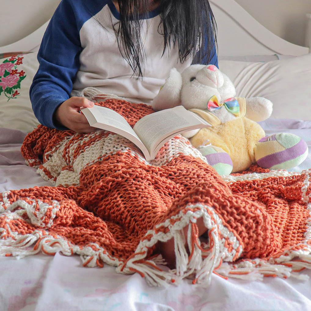 A girl in a bed reading and cover with eri silk summer blanket - Muezart India